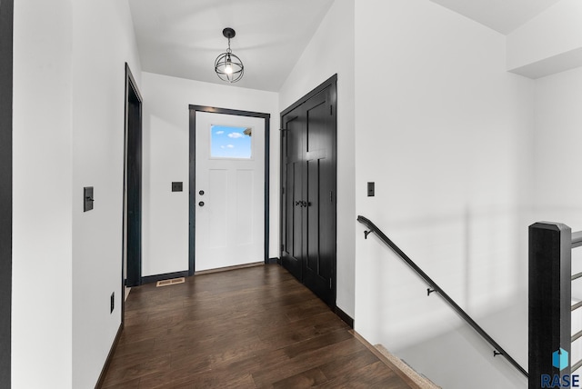 hall featuring dark hardwood / wood-style floors and vaulted ceiling