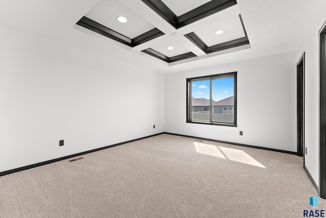 carpeted spare room featuring beamed ceiling and coffered ceiling