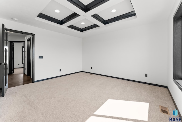 carpeted empty room with coffered ceiling and beam ceiling