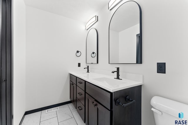 bathroom with vanity and toilet