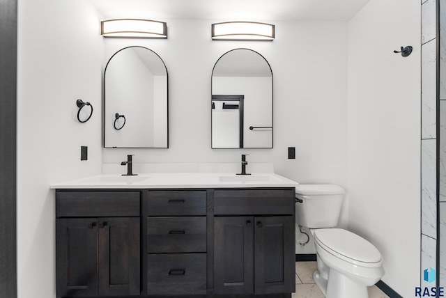 bathroom with vanity, toilet, and tile patterned floors