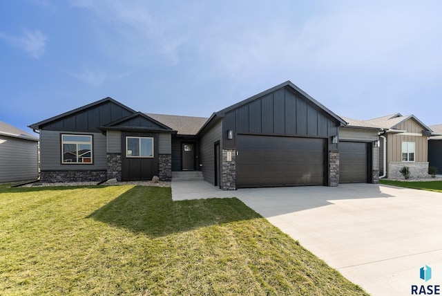 view of front of home with a garage and a front lawn