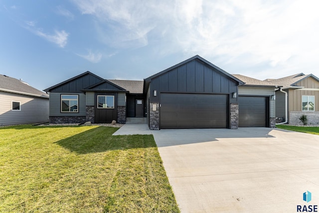 view of front of home with a front yard and a garage