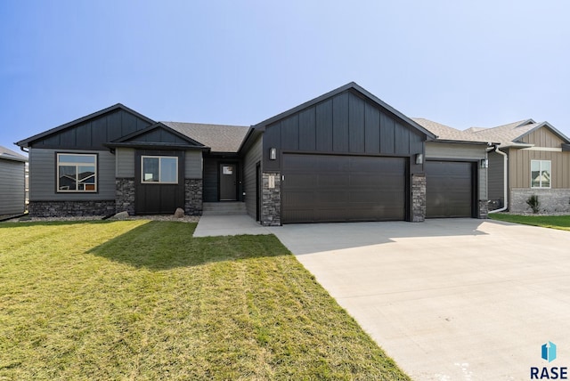 view of front of home with a front yard and a garage