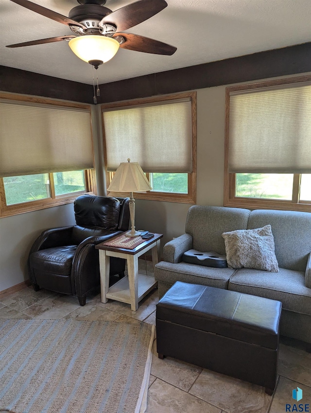 living room featuring ceiling fan and light tile patterned floors