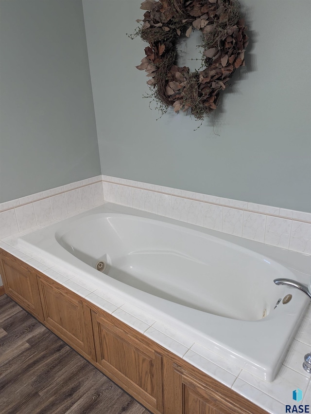 bathroom featuring hardwood / wood-style flooring and a tub