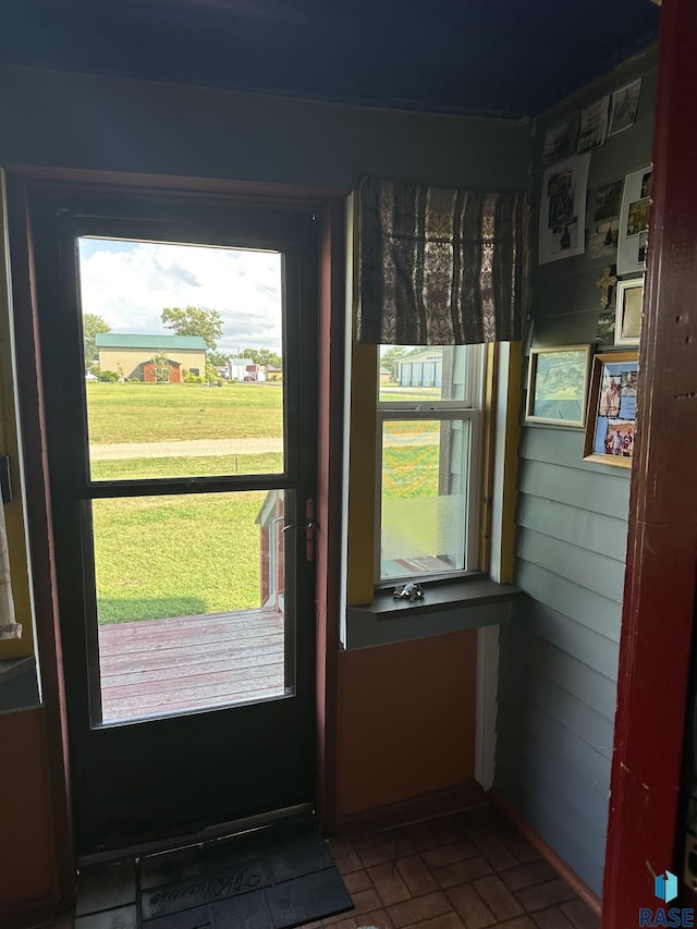 101 N Seaman St, Delmont, SD 57330 - kitchen featuring gas range gas stove, wooden walls, brown cabinetry, washer / dryer, and an inviting chandelier