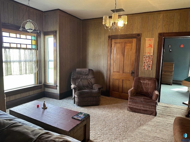 101 N Seaman St, Delmont, SD 57330 - living area featuring carpet flooring, wooden walls, and a notable chandelier
