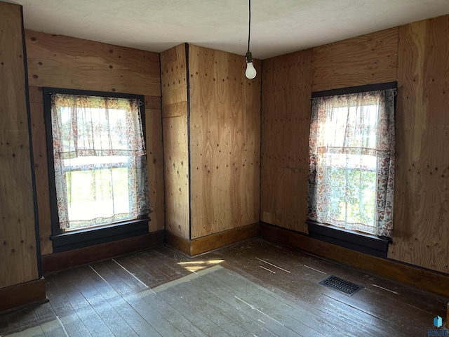 101 N Seaman St, Delmont, SD 57330 - empty room featuring hardwood / wood-style floors, baseboards, and wood walls