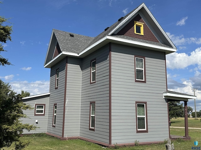 101 N Seaman St, Delmont, SD 57330 - view of home's exterior with roof with shingles and a yard