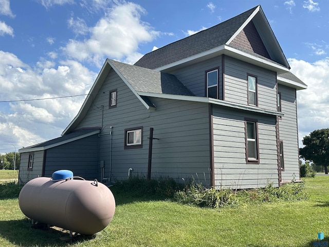 101 N Seaman St, Delmont, SD 57330 - view of home's exterior featuring a lawn and a shingled roof