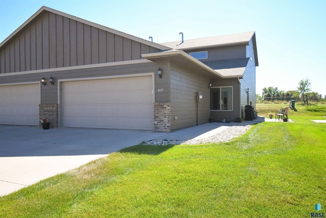 view of front of house with a garage and a front lawn