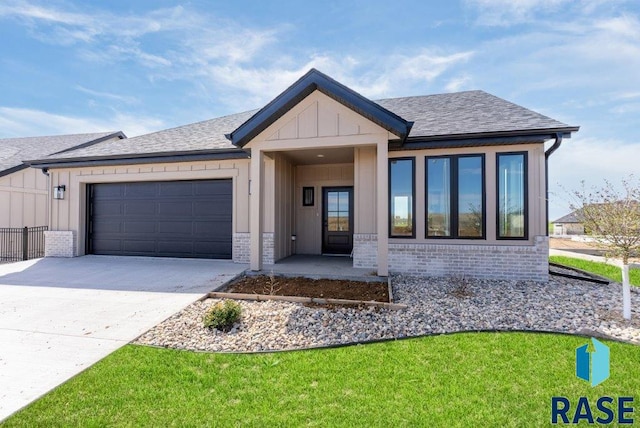 view of front of property with a garage and a front lawn