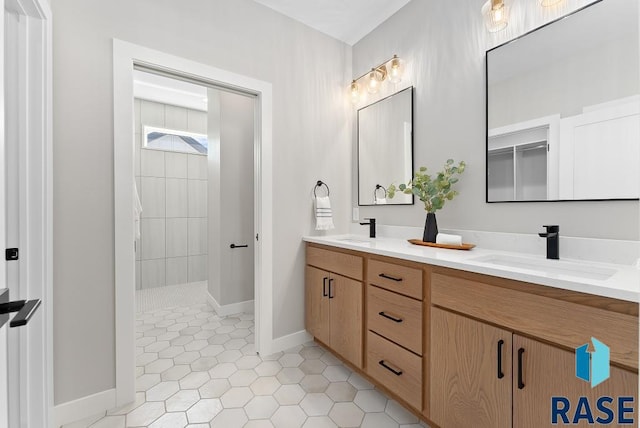 bathroom featuring vanity, a tile shower, and tile patterned floors