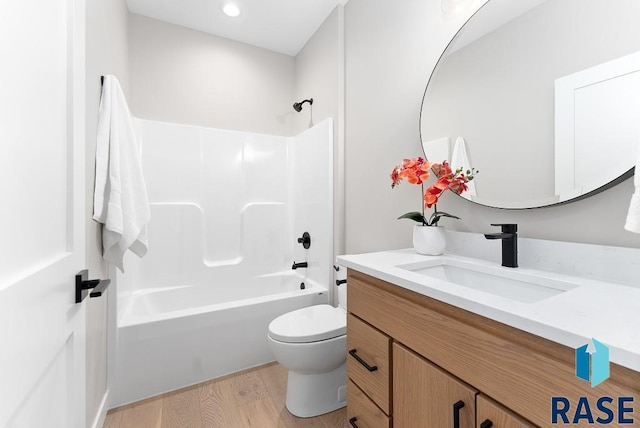 full bathroom with vanity, hardwood / wood-style flooring, shower / bath combination, and toilet