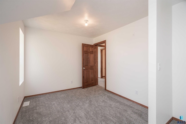 spare room featuring carpet