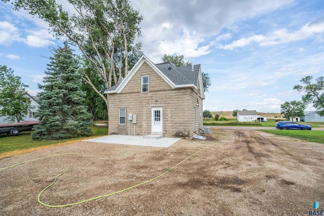 view of side of property with a patio