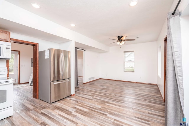 interior space featuring ceiling fan and light wood-type flooring