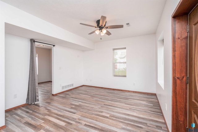 empty room featuring light hardwood / wood-style flooring and ceiling fan