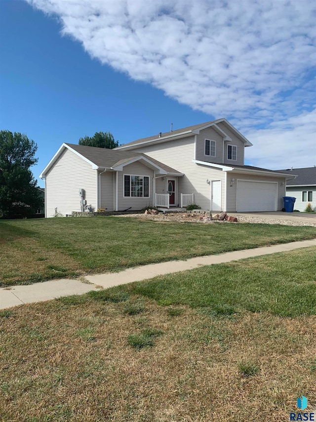 view of front of home with a front lawn and a garage