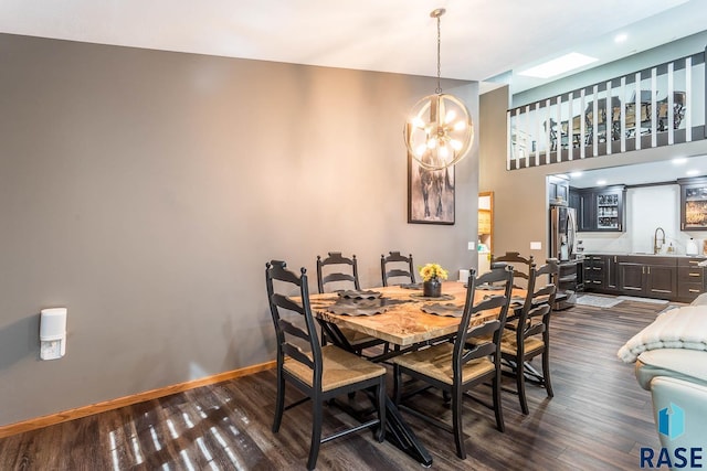 dining room with an inviting chandelier, dark hardwood / wood-style floors, and sink