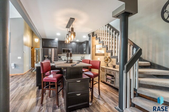 dining area with dark hardwood / wood-style floors and a wood stove