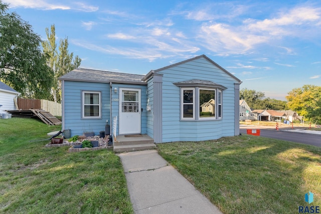 bungalow-style house with a front yard