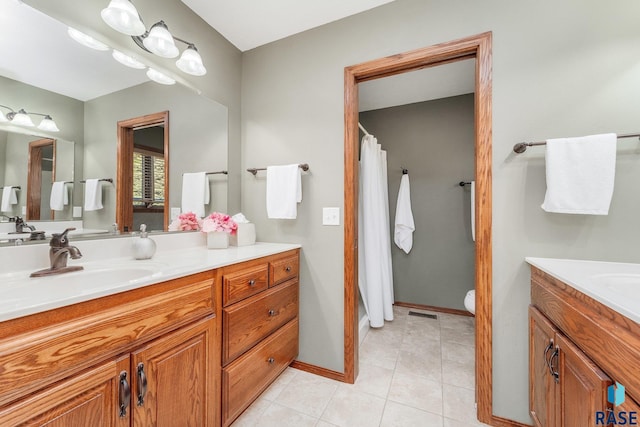 bathroom featuring tile patterned flooring, vanity, and toilet