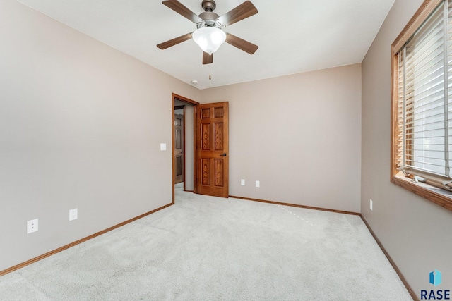 unfurnished bedroom featuring ceiling fan and light colored carpet