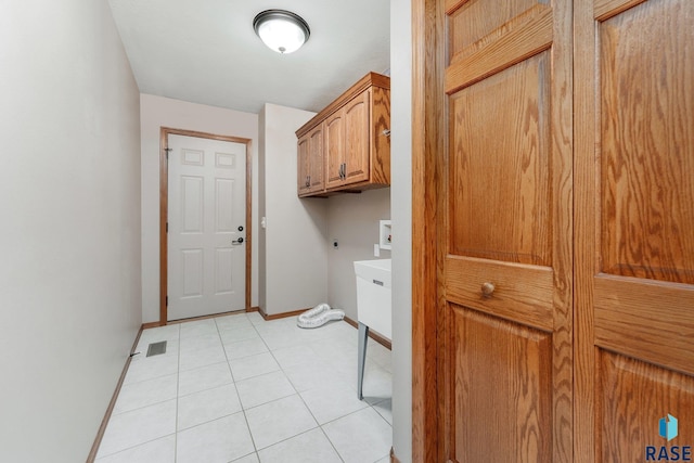 laundry area featuring cabinets, washer hookup, light tile patterned floors, and hookup for an electric dryer