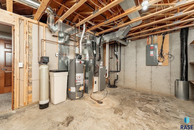 basement featuring electric panel, water heater, and heating unit