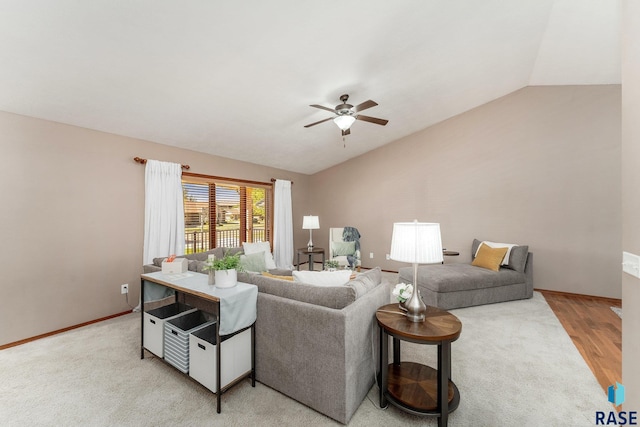 living room with hardwood / wood-style floors, ceiling fan, and vaulted ceiling