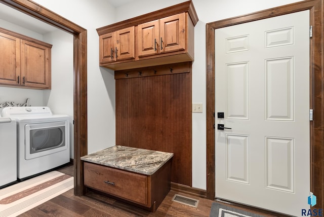 laundry area with cabinets, washer and clothes dryer, and dark hardwood / wood-style flooring