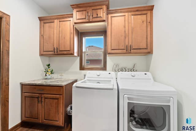 laundry area featuring cabinets, dark hardwood / wood-style floors, and independent washer and dryer