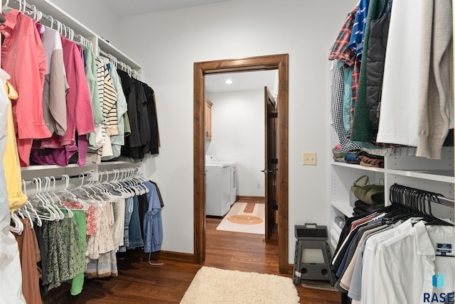 spacious closet featuring washer and clothes dryer and dark hardwood / wood-style floors