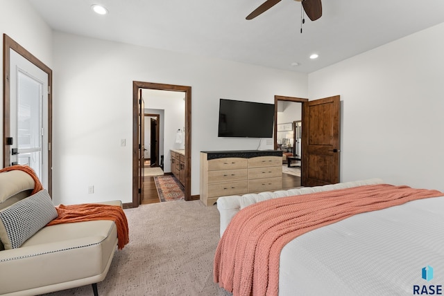 carpeted bedroom with connected bathroom and ceiling fan