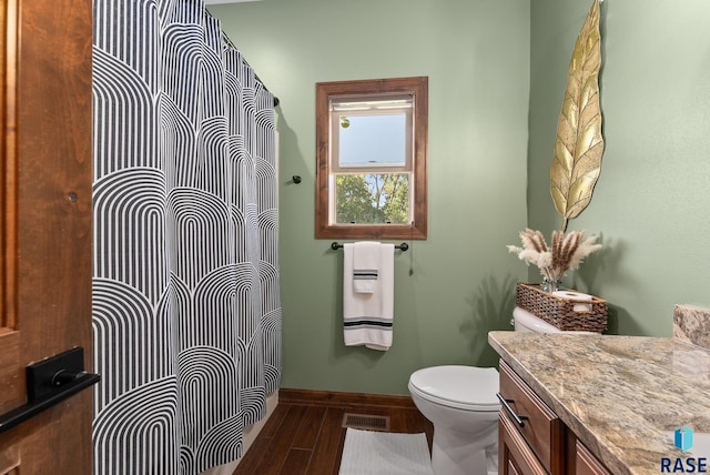 bathroom with vanity, hardwood / wood-style floors, and toilet