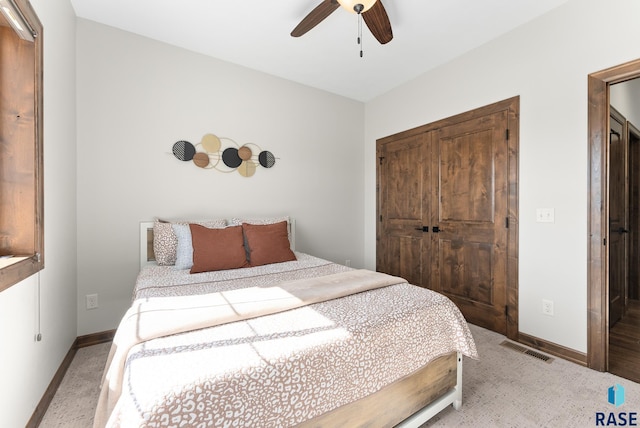 carpeted bedroom with a closet and ceiling fan