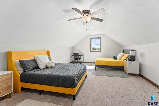 bedroom featuring vaulted ceiling, ceiling fan, carpet floors, and a textured ceiling