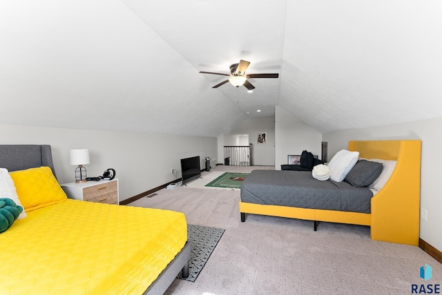 carpeted bedroom with vaulted ceiling and ceiling fan