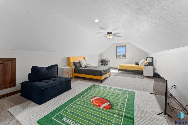 bedroom with carpet floors, a textured ceiling, lofted ceiling, and ceiling fan