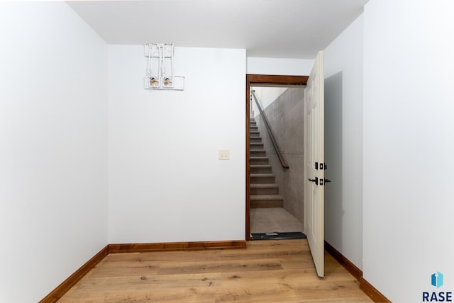 stairway with a chandelier and hardwood / wood-style flooring