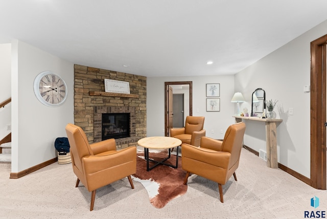 living room with a stone fireplace and carpet