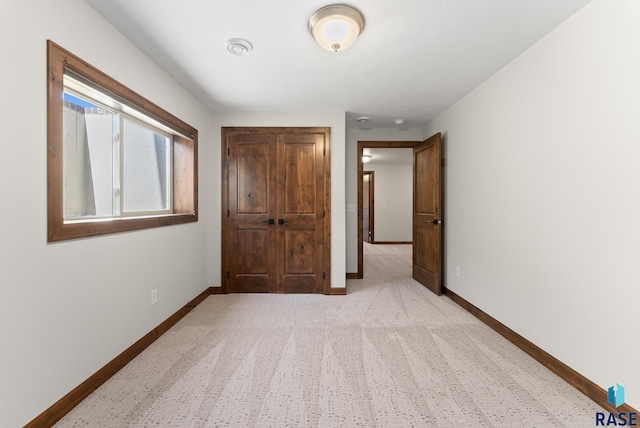 unfurnished bedroom with light colored carpet