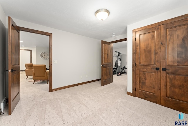 bedroom with light carpet and a closet