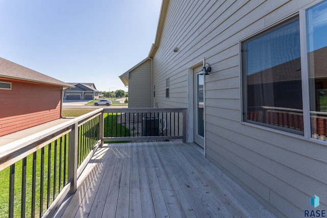 wooden deck with a lawn