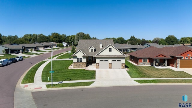 view of front of property with a garage and a front lawn