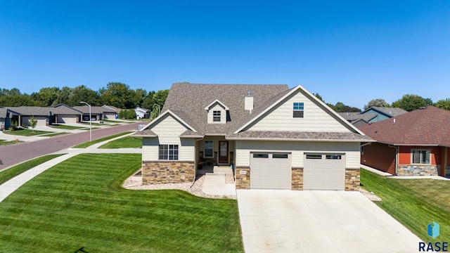 view of front of home featuring a garage and a front lawn