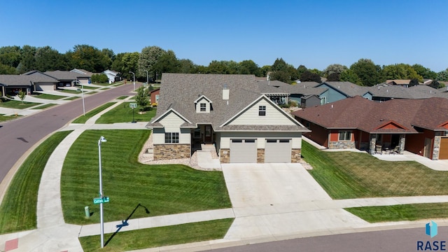 view of front of home with a front yard and a garage