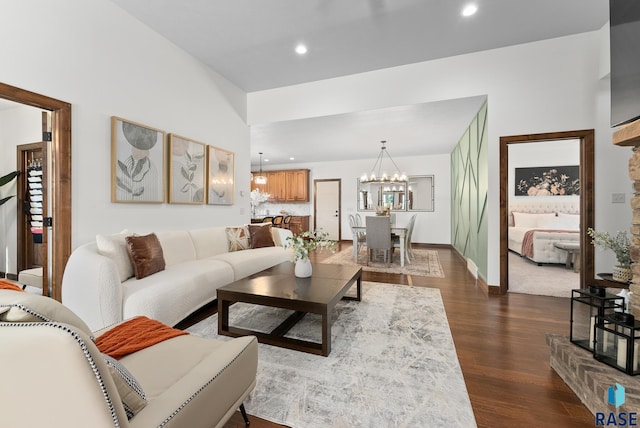 living room featuring a high ceiling, dark hardwood / wood-style floors, and a chandelier